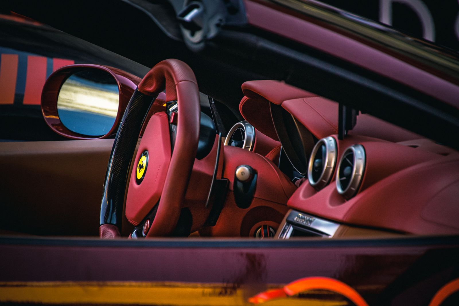 Red leather sports car seats and steering wheel